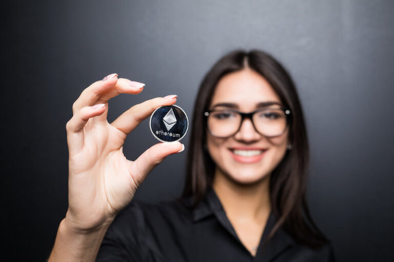 Young business woman with litecoin in hands.