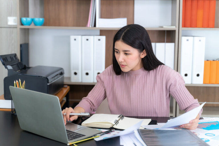 Young beautiful working with laptop on table in office.