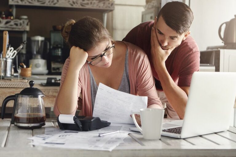 Young stressed couple facing financials troubles.
