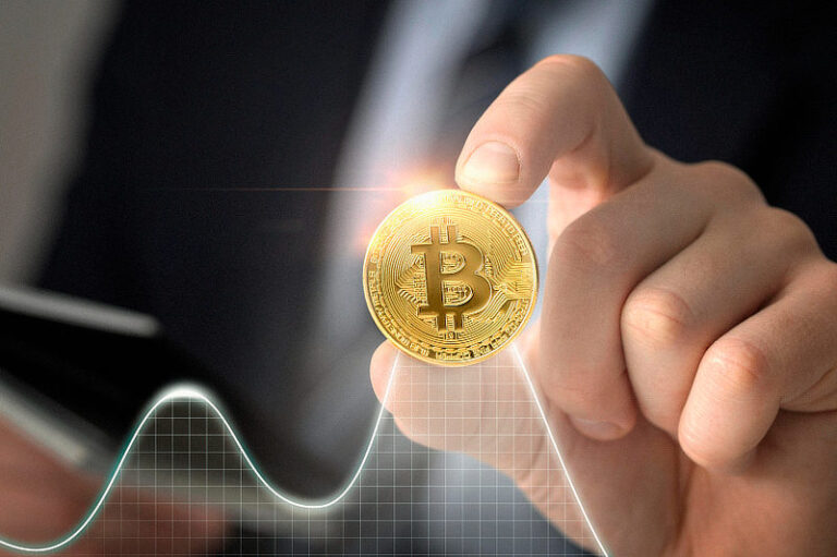 Close up hand holding coin.